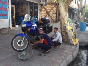 Oil change and wash on the street in Bam, Iran